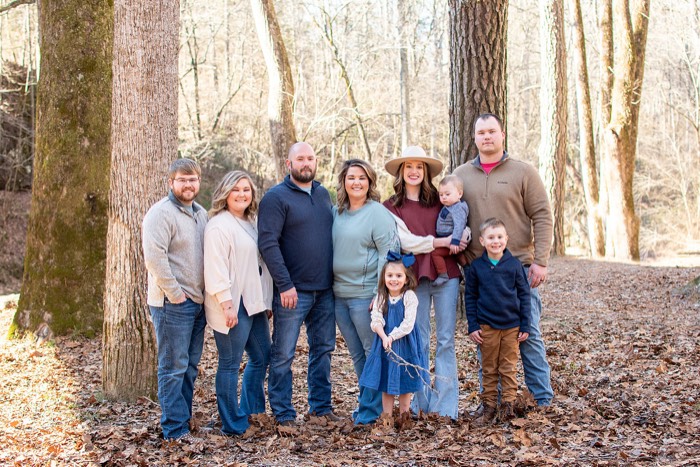 Extended family gathered for a portrait in a North Alabama woodland