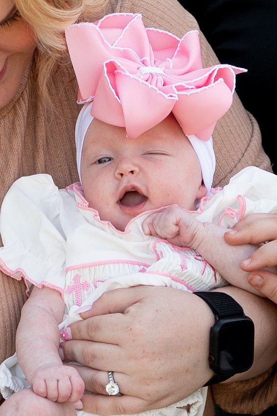 Baby smiling while held in a parent’s arms