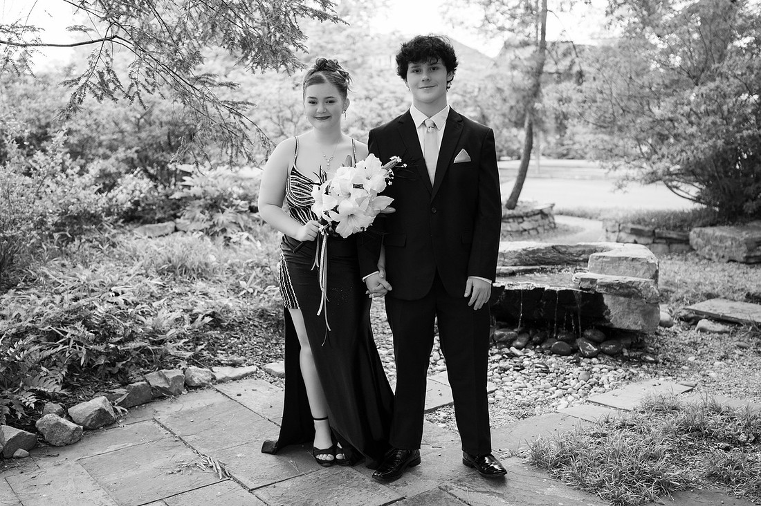 Young couple dressed for prom in a garden