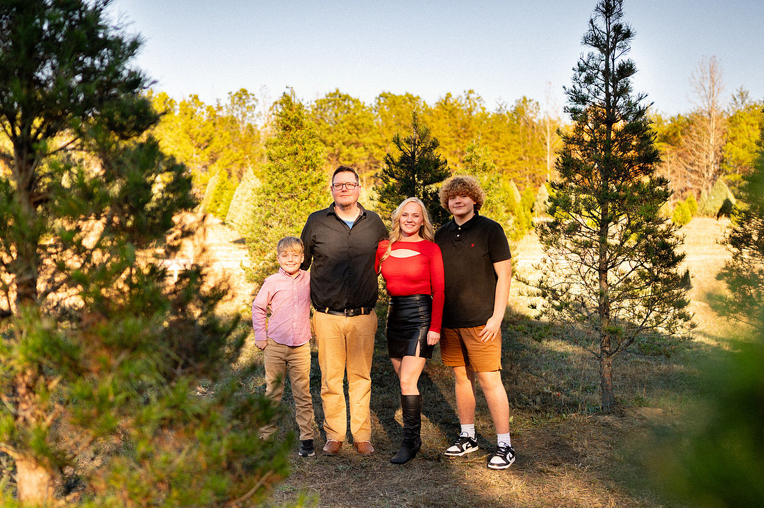 Family of four gathered outdoors