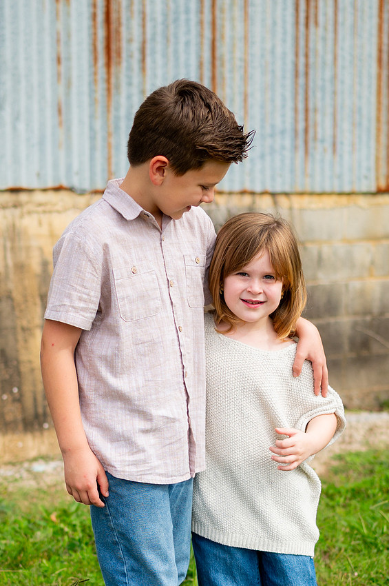 Brother and sister standing together outdoors